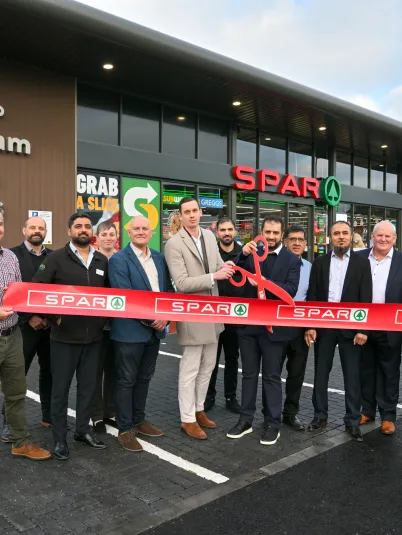 Store staff and a f blakemore employees in front of a SPAR store