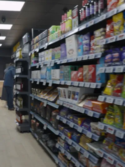 Various products on shelves in a convenience retail store.