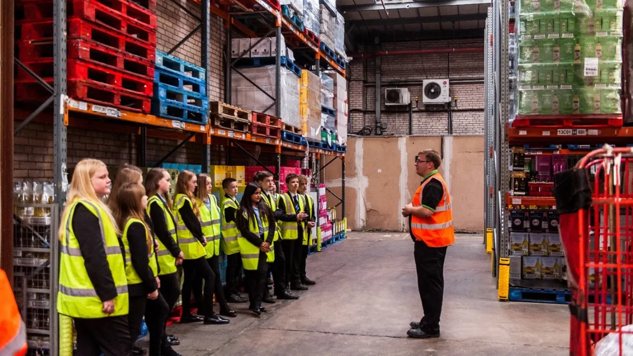 A F Blakemore warehouse staff member telling a group of visiting school children about the warehouse and how it operates.