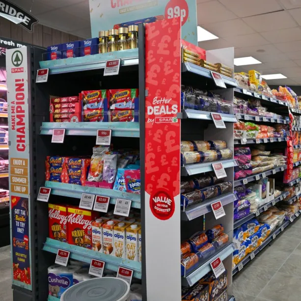 Products on a shelf in a SPAR convenience store with value on your doorstep point of sale on display.