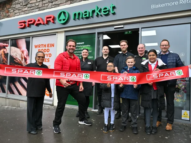 A F Blakemore staff members standing in front of a SPAR market branded convenience store.